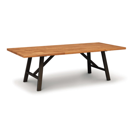 A rectangular Copeland Furniture Modern Farmhouse Trestle Farm Table made of natural cherry hardwood with a smooth top and angled black metal legs on a white background.