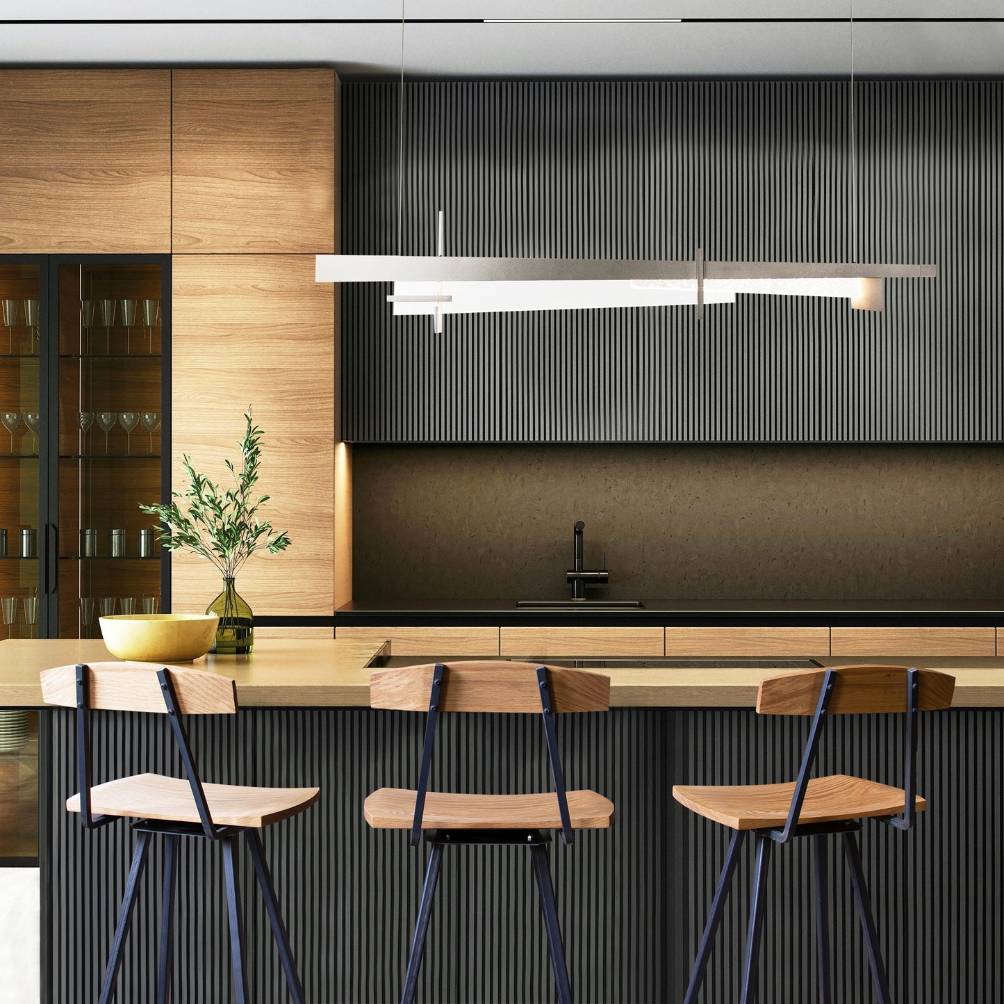 Modern Industrial Stool with Back by Vermont Woods Studios, featuring a sleek wood seat and sturdy frame, positioned at a light wood kitchen island.