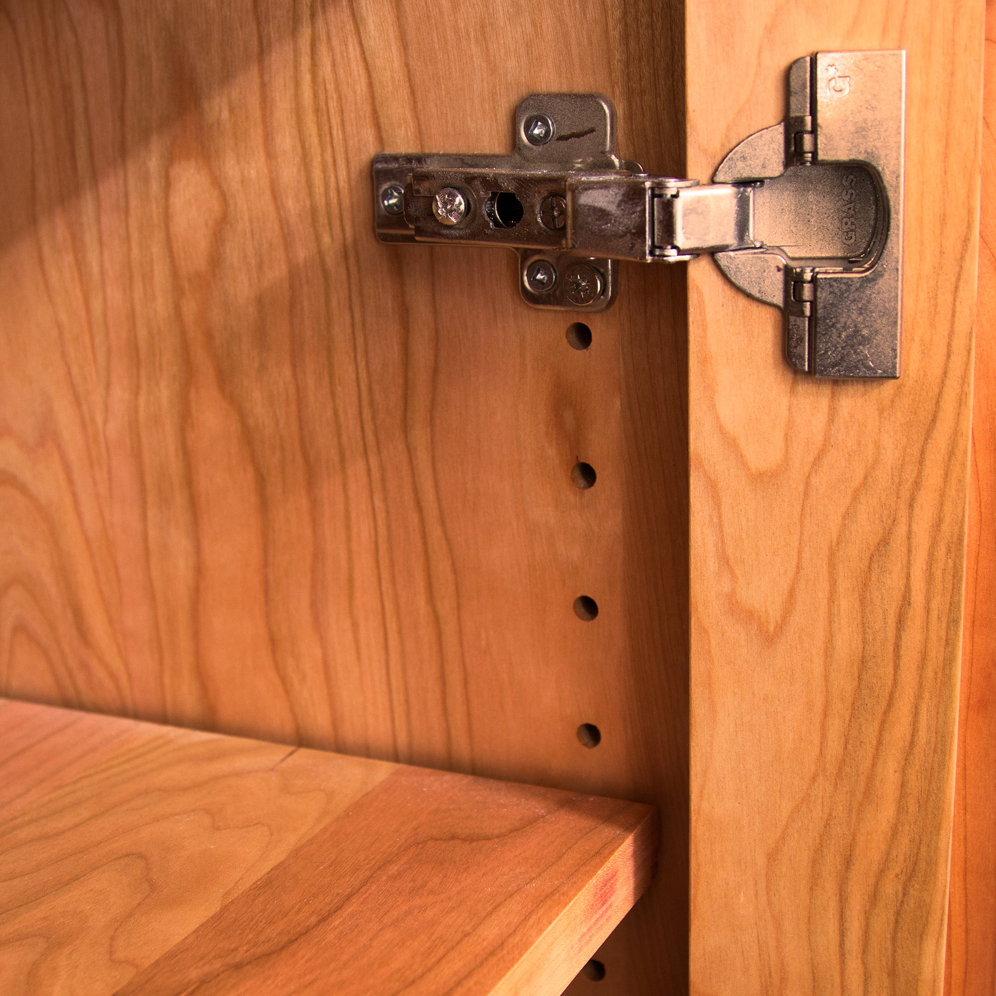 Detail view of solid wood craftsmanship and metal hinge on the Lyndon Furniture Modern Mission Buffet.