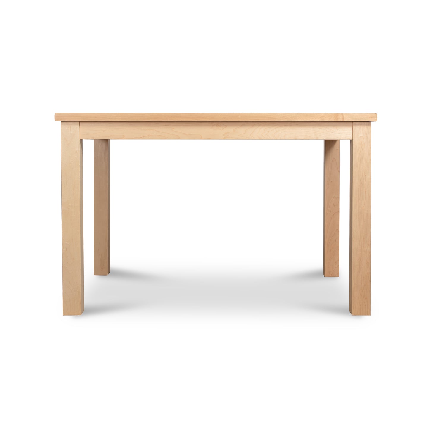 The Modern Mission Parsons Solid Top Table by Lyndon Furniture is a rectangular maple table with a light, natural finish. Handcrafted in Vermont, it features four straight legs and a simple, minimalistic design. The tabletop is smooth and flat, suitable for dining or workspace purposes. The background is white and eco-friendly. This 36"x48" table is currently available on clearance.