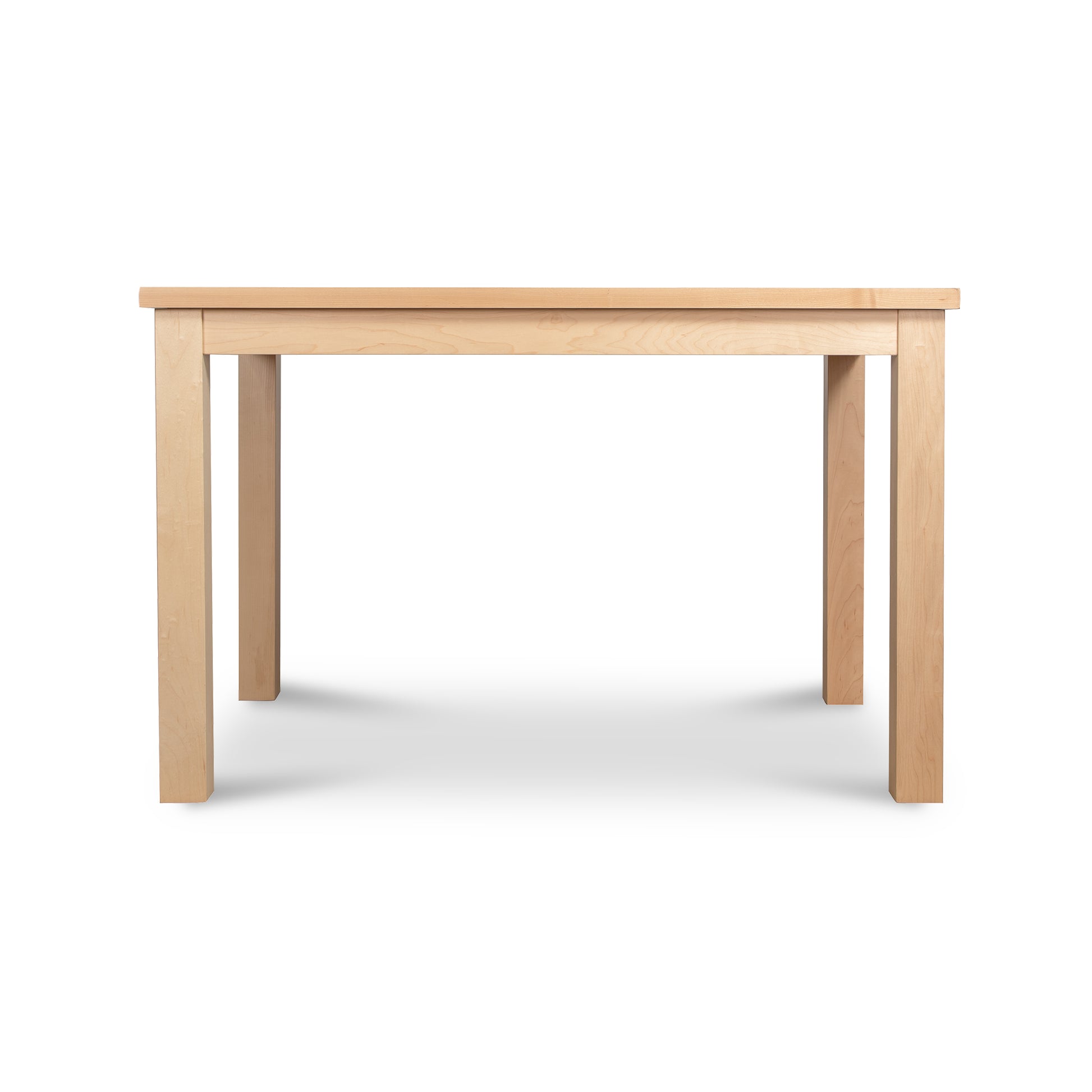 The Modern Mission Parsons Solid Top Table by Lyndon Furniture is a rectangular maple table with a light, natural finish. Handcrafted in Vermont, it features four straight legs and a simple, minimalistic design. The tabletop is smooth and flat, suitable for dining or workspace purposes. The background is white and eco-friendly. This 36"x48" table is currently available on clearance.