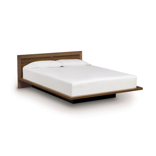 The Moduluxe Platform Bed with Clapboard Headboard - 29" Series by Copeland Furniture features a beautiful wooden headboard and footboard, making it a stunning addition to any bedroom.