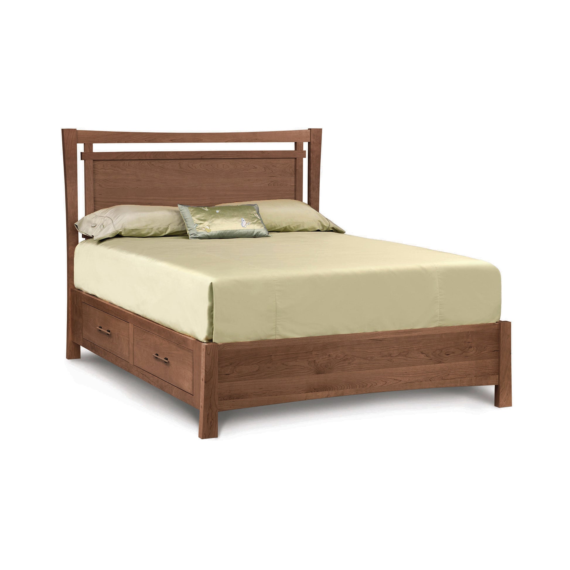 A solid cherry wood queen-sized Copeland Furniture Monterey Storage Bed frame with underbed storage, a light green sheet set, and a single decorative pillow.