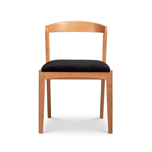 Montgomery Chair by Vermont Woods Studios with cherry frame, curved backrest, and black seat, crafted in America. High quality, modern wooden chair.