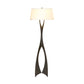 A Moreau Floor Lamp by Hubbardton Forge with a white shade.