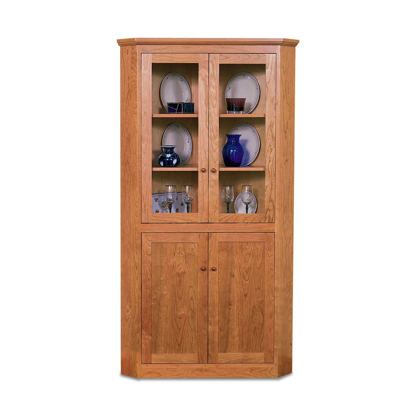 New England Shaker corner cabinet by Lyndon Furniture with glass display doors and concealed storage, crafted from sustainable wood.