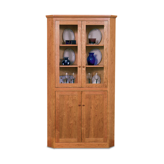 New England Shaker corner cabinet by Lyndon Furniture with glass display doors and concealed storage, crafted from sustainable wood.
