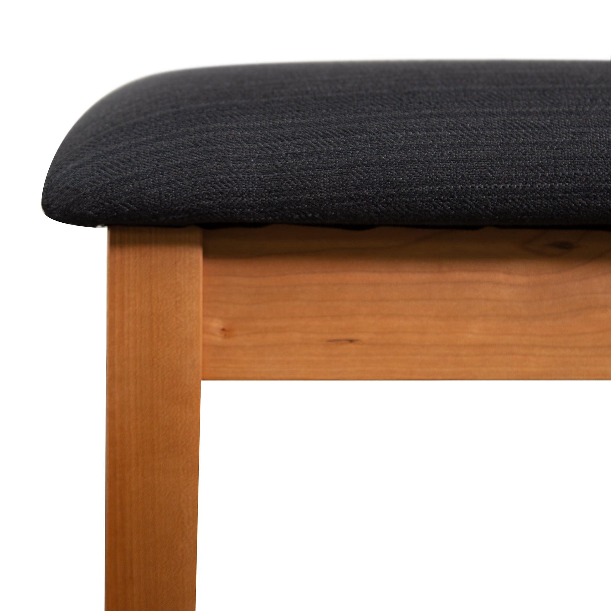 Lyndon Furniture New England Shaker Dressing Stool in cherry with black cushion, showcasing sustainable wood craftsmanship and elegant leg design.
