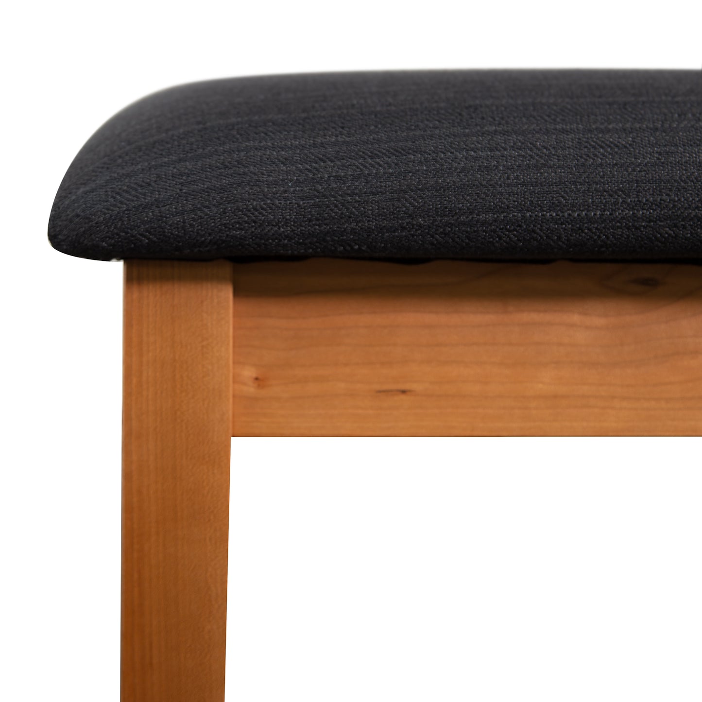Lyndon Furniture New England Shaker Dressing Stool featuring a sleek wooden leg and black upholstered seat in close detail.