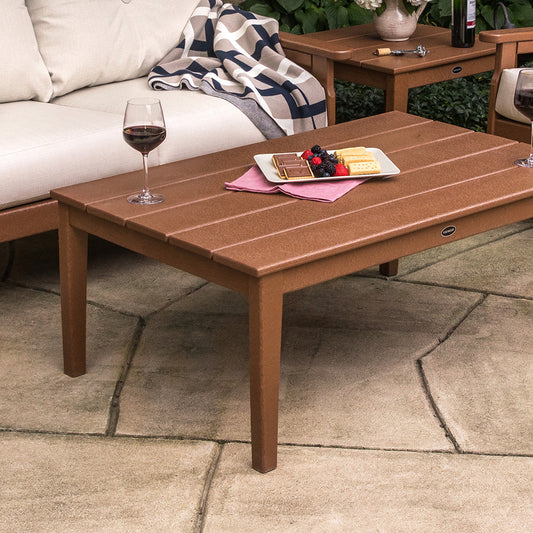 POLYWOOD Newport Coffee Table with two glasses of red wine, chocolate, and berries placed on top.