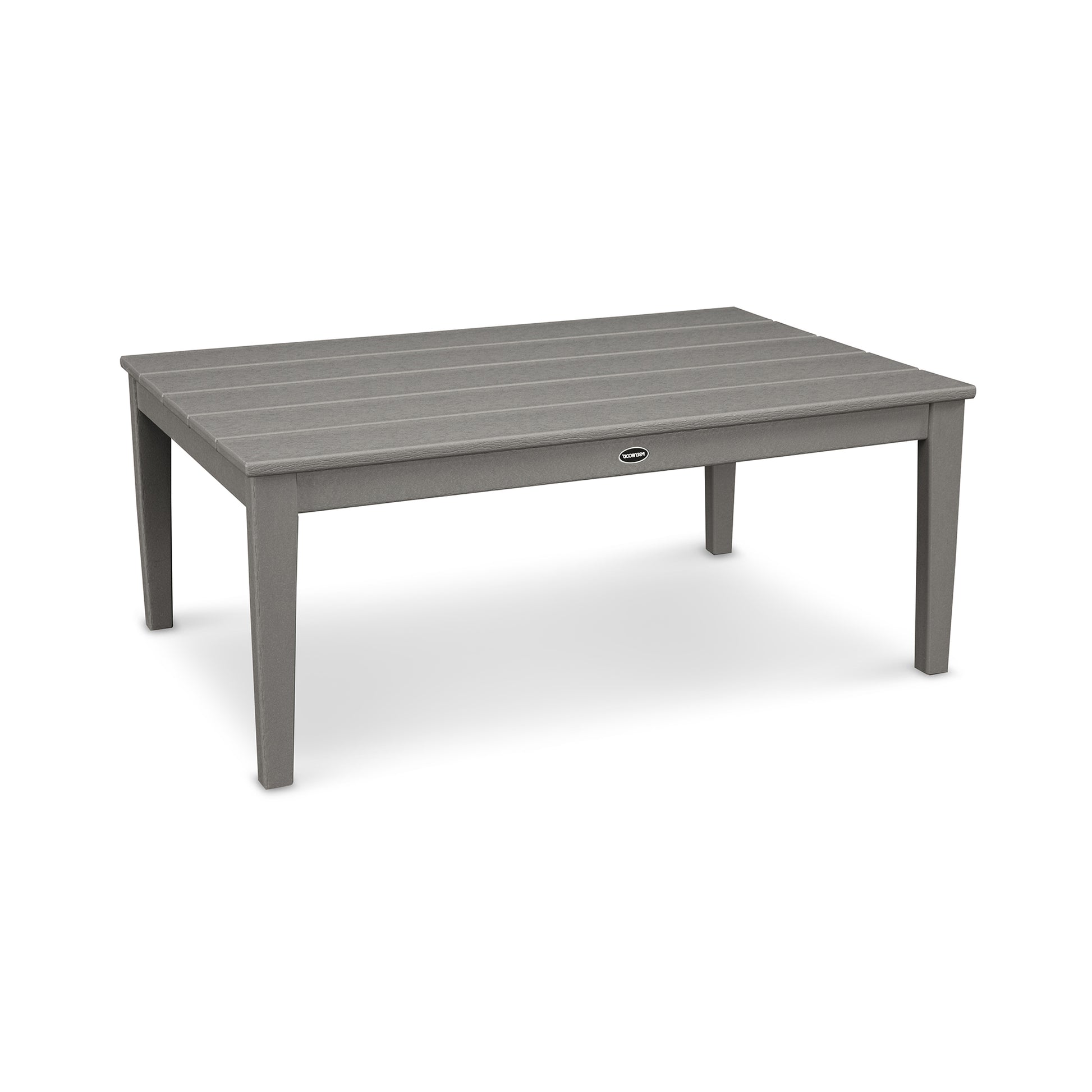 A rectangular gray POLYWOOD Newport 28" x 42" Coffee Table made from POLYWOOD® recycled plastic lumber, with a slatted top and four sturdy legs, isolated on a white background. The table features a small round metal emblem.