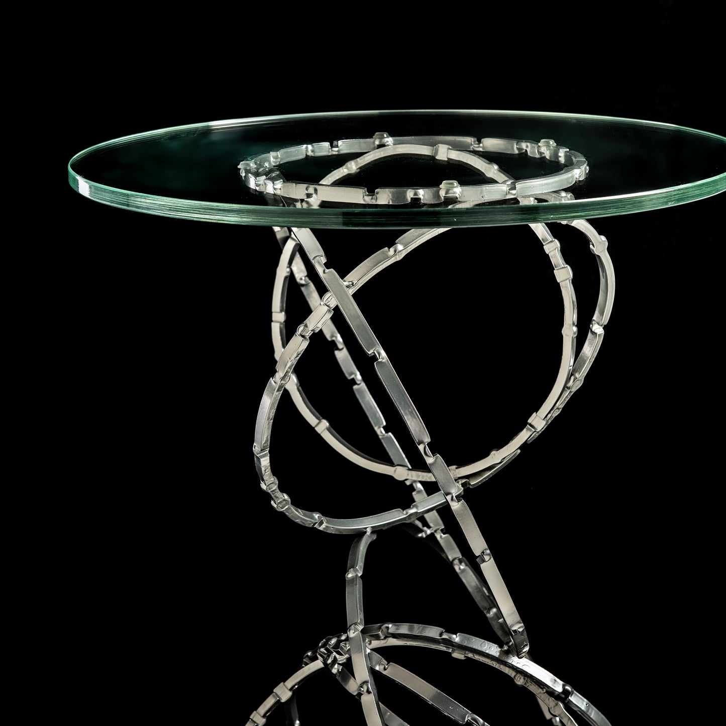 Olympus Glass Top Accent Table by Hubbardton Forge with distinctive metallic ring support.