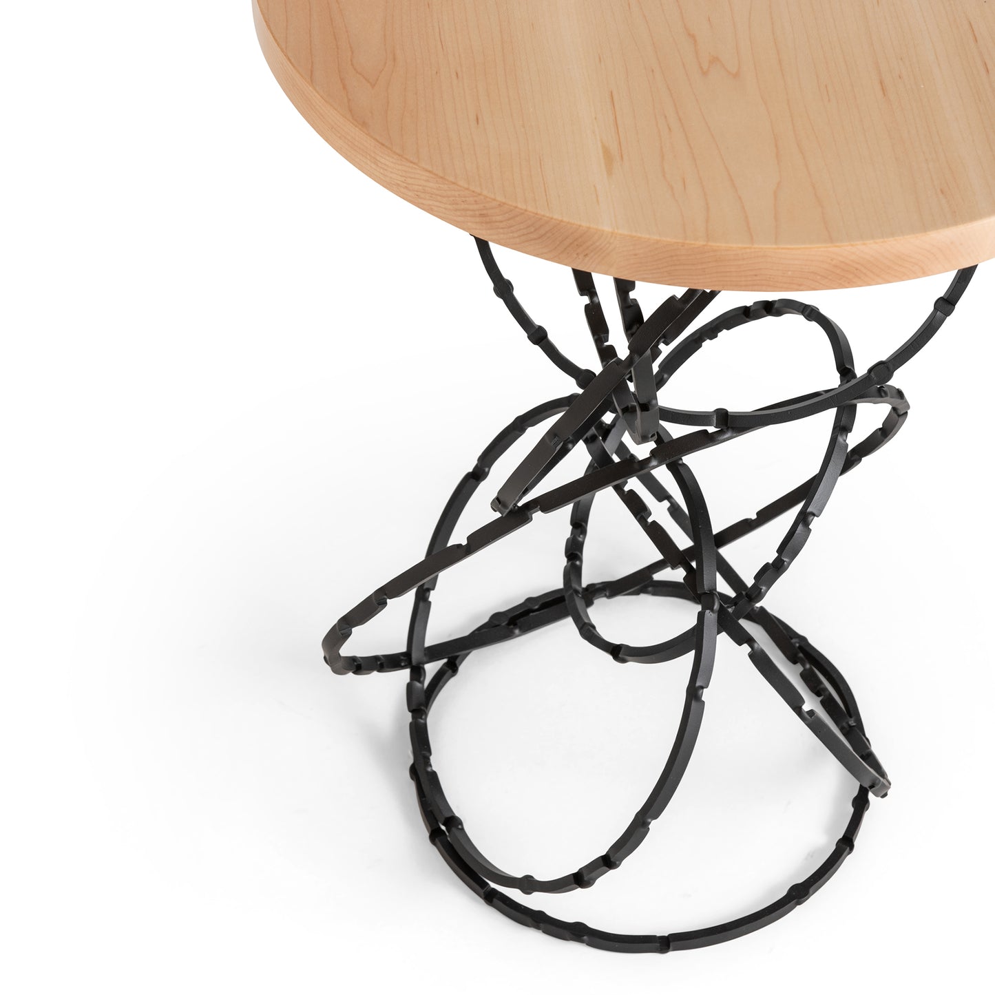 Olympus Accent Table by Hubbardton Forge with round Vermont maple tabletop and detailed black metal base.