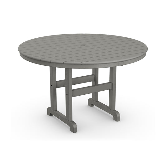 Round, gray POLYWOOD® Outdoor 48" Round Dining Table with a smooth top and sturdy base, constructed from durable plastic. The design features evenly spaced, slatted details on the tabletop.