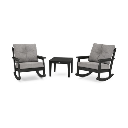 Two gray cushioned POLYWOOD Vineyard 3-Piece Deep Seating Rocker Set chairs and a small black rectangular table on a white background. The chairs, made from eco-friendly POLYWOOD lumber, have dark frames and are positioned facing