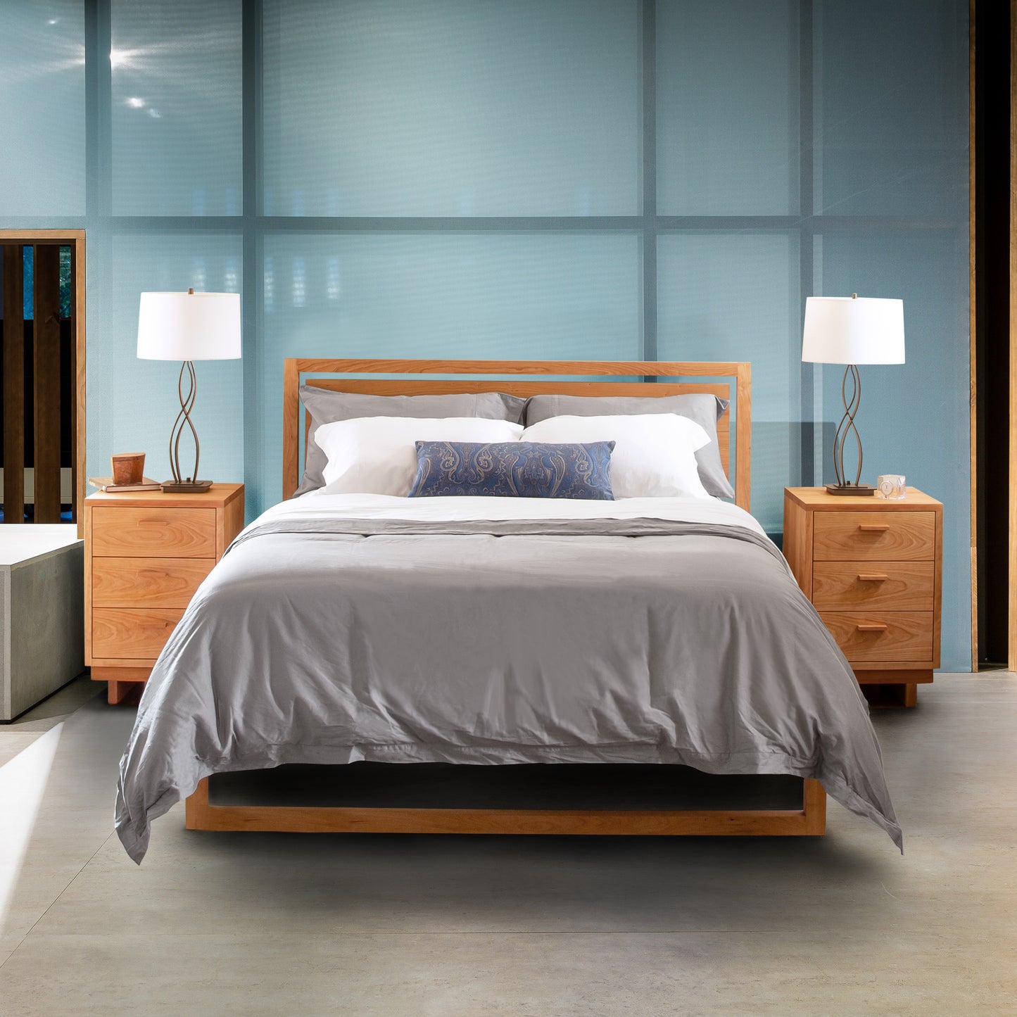 Vermont Furniture Designs Pendant Bed with gray bedding and matching nightstands featuring white lamps.