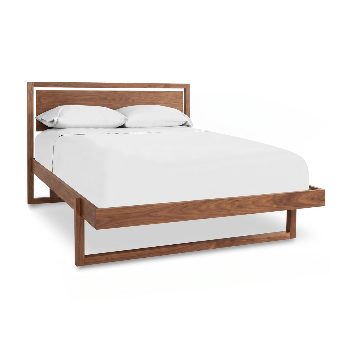 Modern cherry wood frame Pendant Bed by Vermont Furniture Designs with white mattress and pillows.