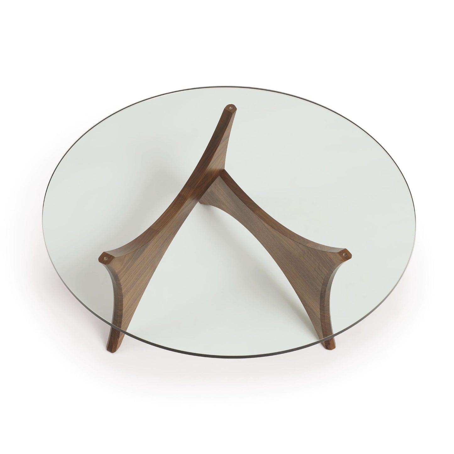 Pivot Round Coffee Table by Copeland Furniture, showcasing a tempered glass top supported by three solid walnut legs in a distinctive triangular base.