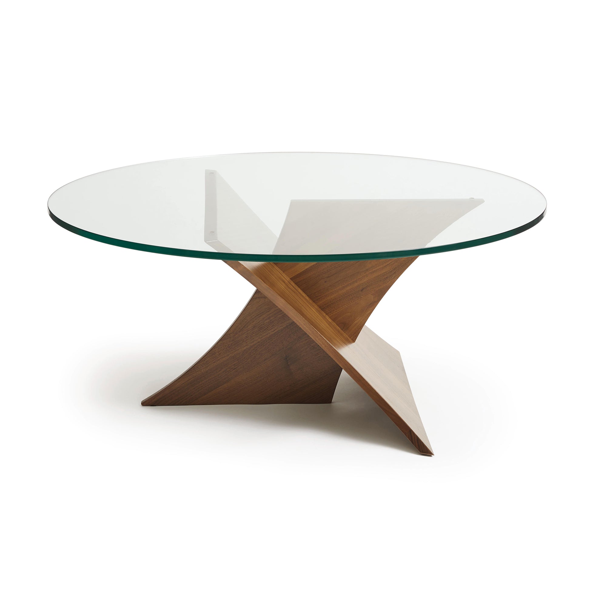 A modern Copeland Furniture Planes Round Glass Top Coffee Table with a walnut base featuring intersecting supports and a tempered glass top on a white background.