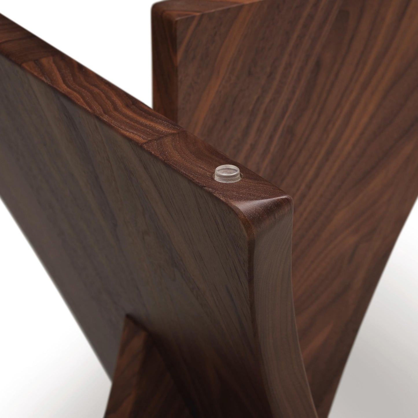 Close-up of a Copeland Furniture Planes Round Glass Top End Table corner joined by a visible screw on a seamless background.