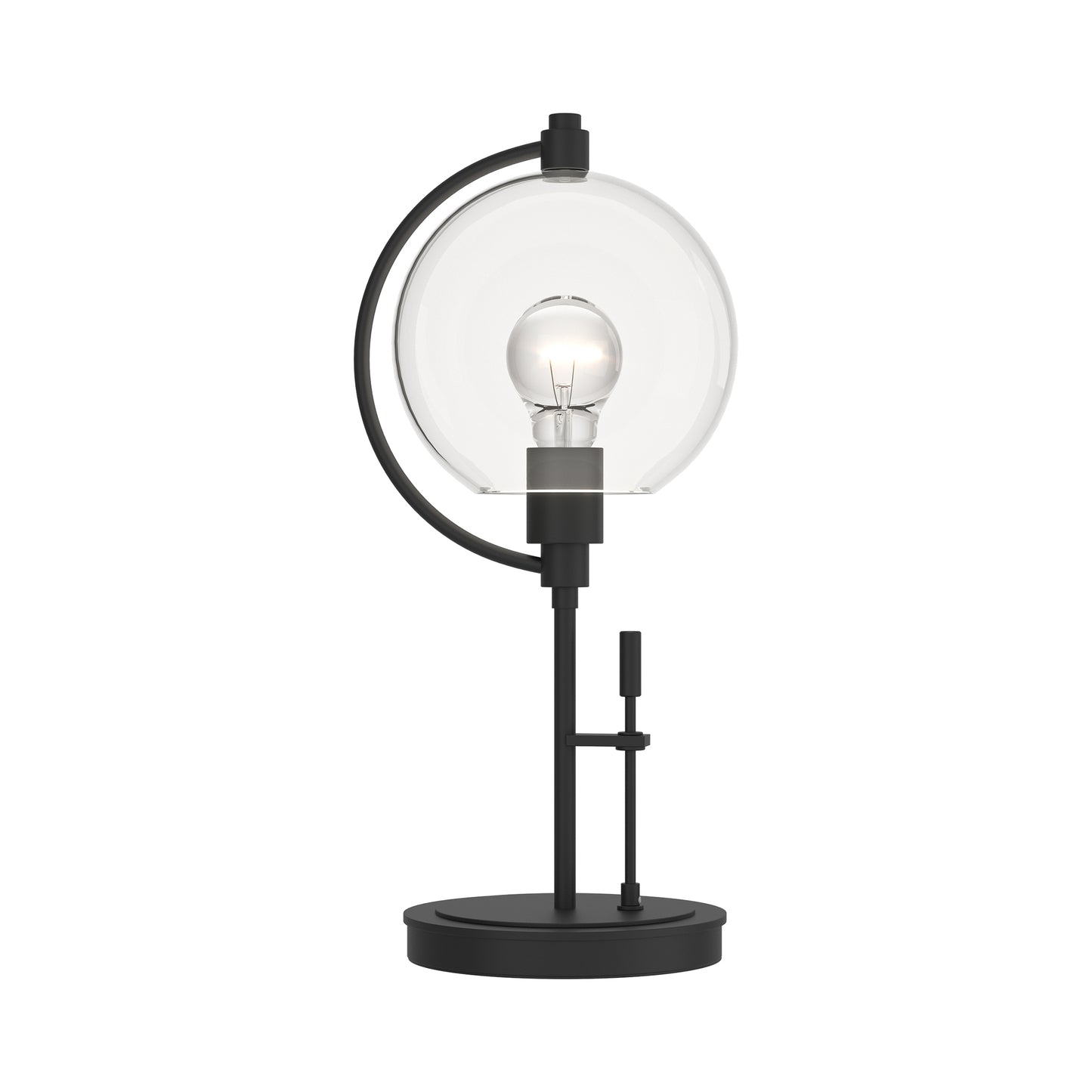 Hubbardton Forge Pluto Table Lamp with handcrafted black metal frame, round glass shade, and exposed bulb on a circular base.