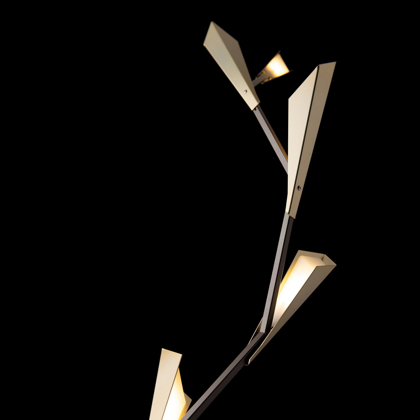 Quill Torchiere floor lamp by Hubbardton Forge with three angular beige shades on a dark metal stem, highlighting modern American-made craftsmanship.