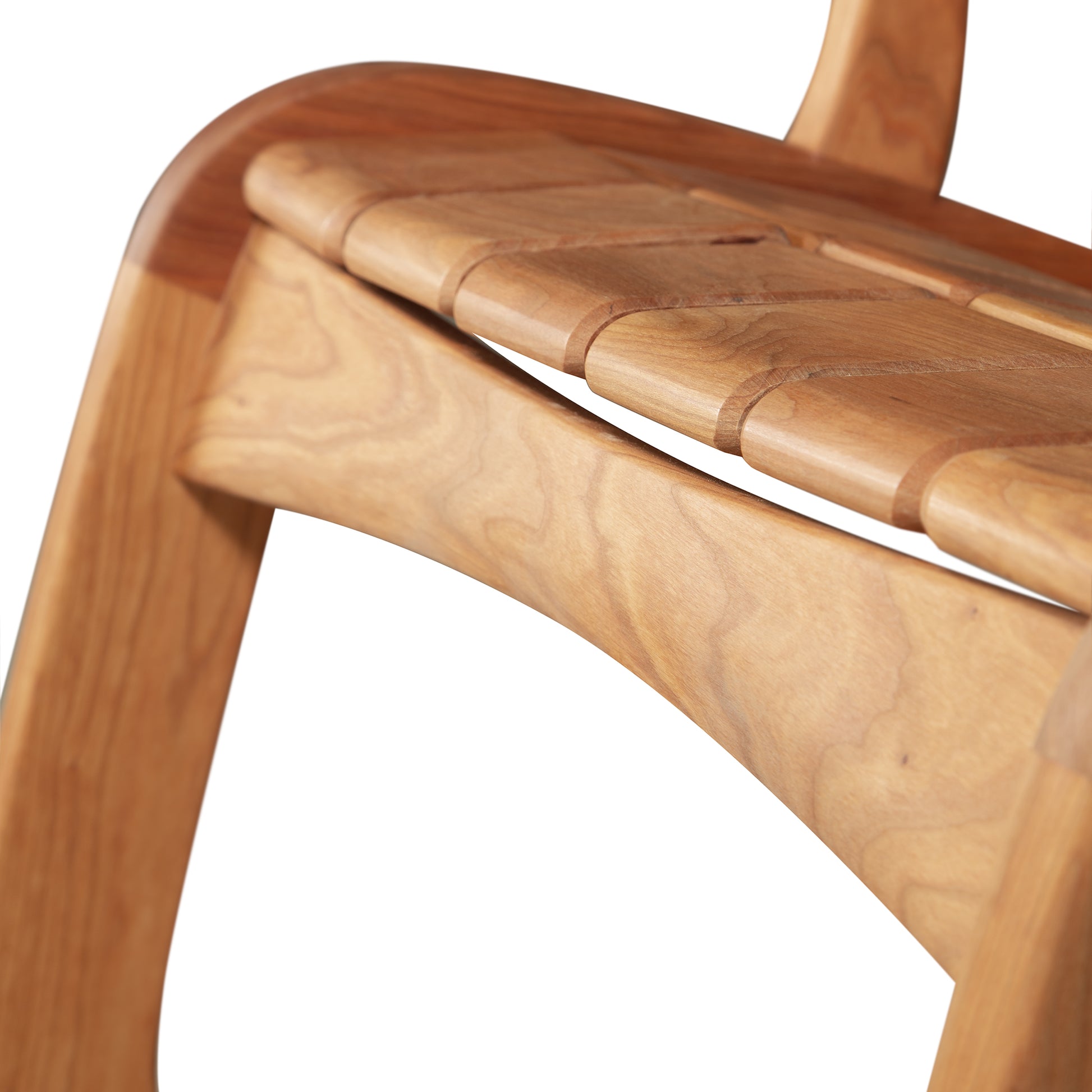 Close-up of Vermont Folk Rocker Special Order Quilted Rocking Chair, highlighting its elegant curves and distinctive natural wood grain craftsmanship.