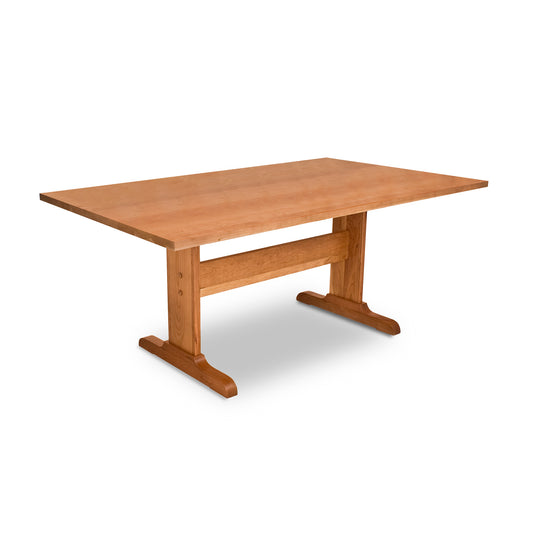 An eco-friendly Rectangular Trestle Solid Top Table from Lyndon Furniture with two legs made from sustainably harvested woods on a white background.