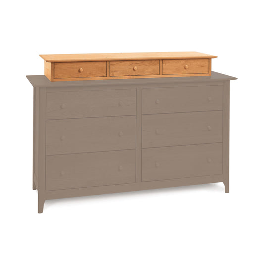 A modern Copeland Furniture Sarah Accessory Case featuring a combination of eco-friendly cherry wood finish on the top drawers and a matte gray finish on the remaining structure, including six drawers with round knobs.