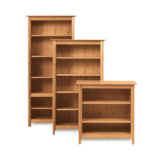 Three empty solid wood Sarah Shaker Bookcases of varying sizes isolated on a white background from the Copeland Furniture Custom Sarah Shaker Home Office Furniture Collection.