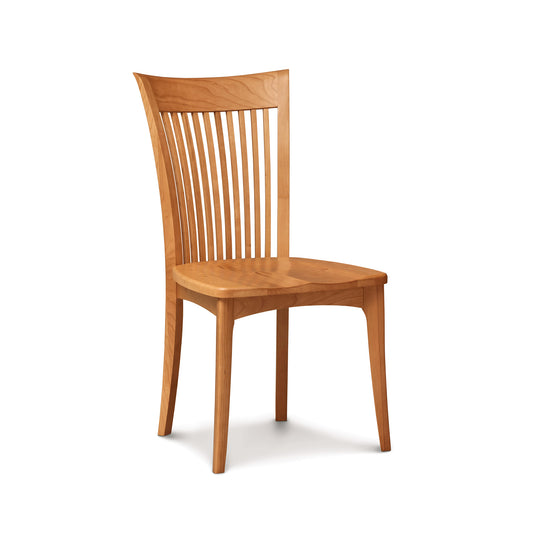 A solid American cherry wood Sarah Shaker Cherry Chair with Wooden Seat, with vertical slats in the backrest, standing isolated against a white background. (Copeland Furniture)