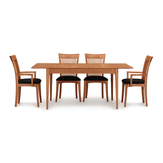 A modern Copeland Furniture Sarah Shaker Tapered Leg Extension Table dining set with four chairs on a plain background.
