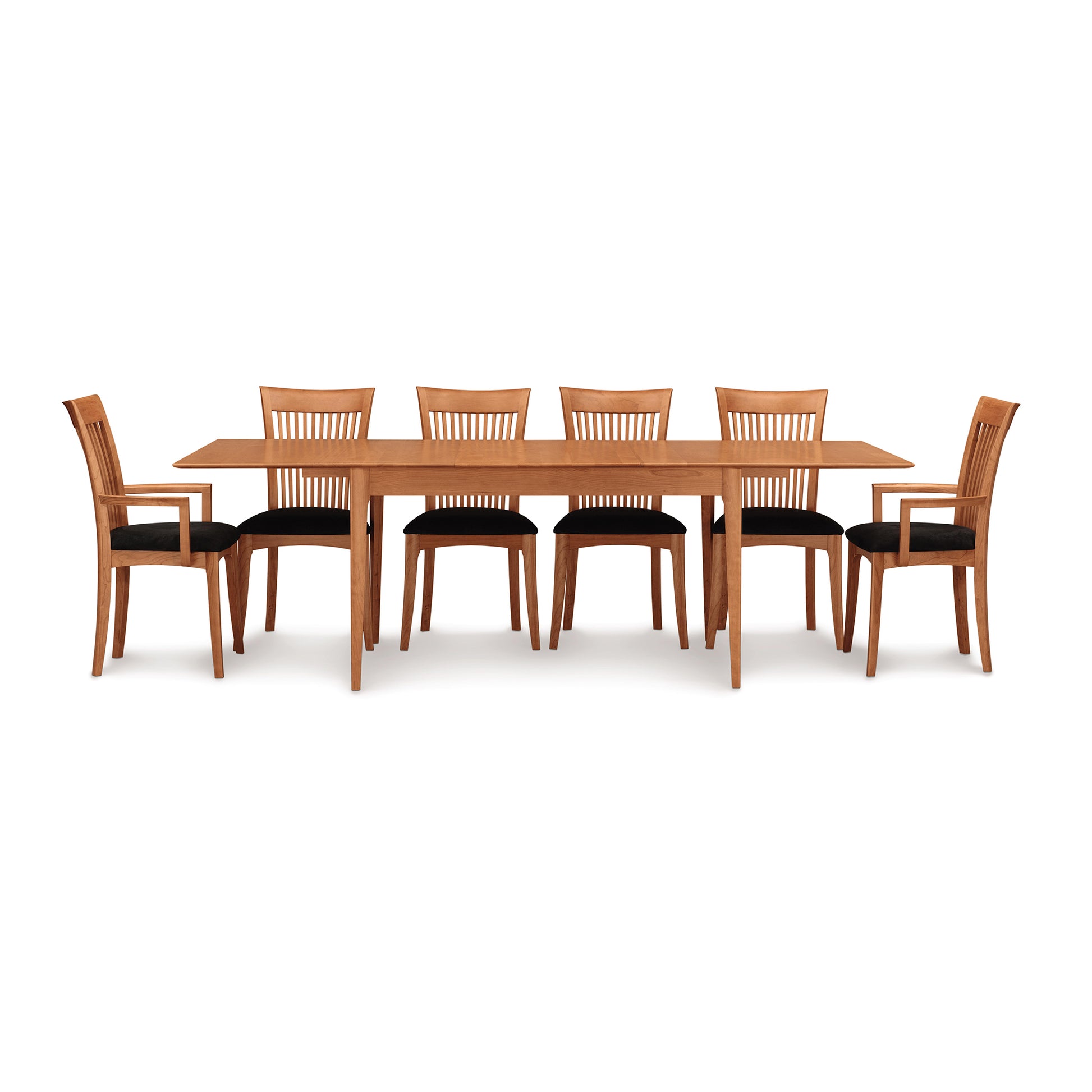 A set of USA made wooden dining furniture from the Copeland Furniture Sarah Shaker dining room collection, including one Sarah Shaker Tapered Leg Extension Table and six chairs arranged on a white background.