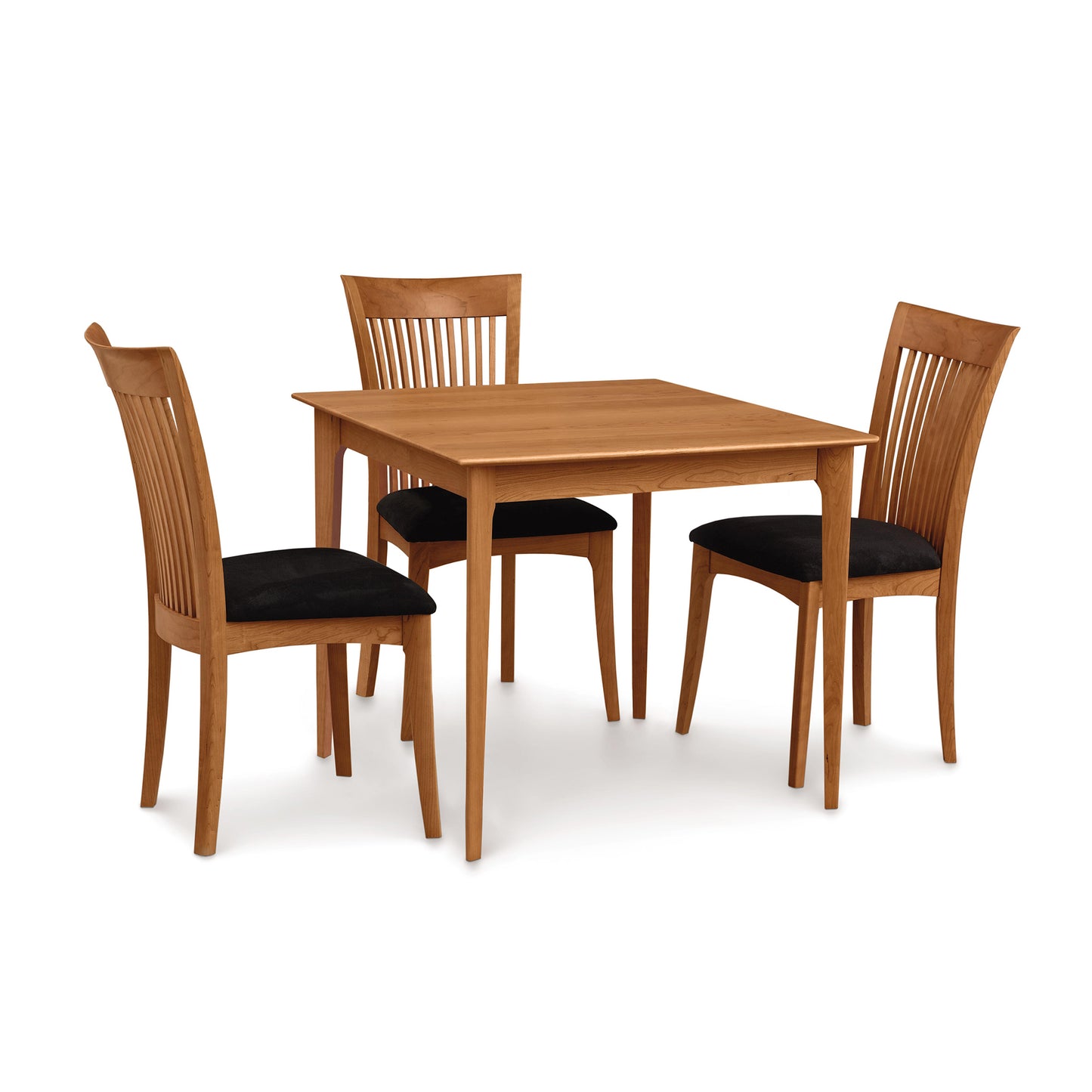 A Sarah Shaker Tapered Leg Solid Top Table from Copeland Furniture with four matching chairs, each with black cushions, isolated on a white background.