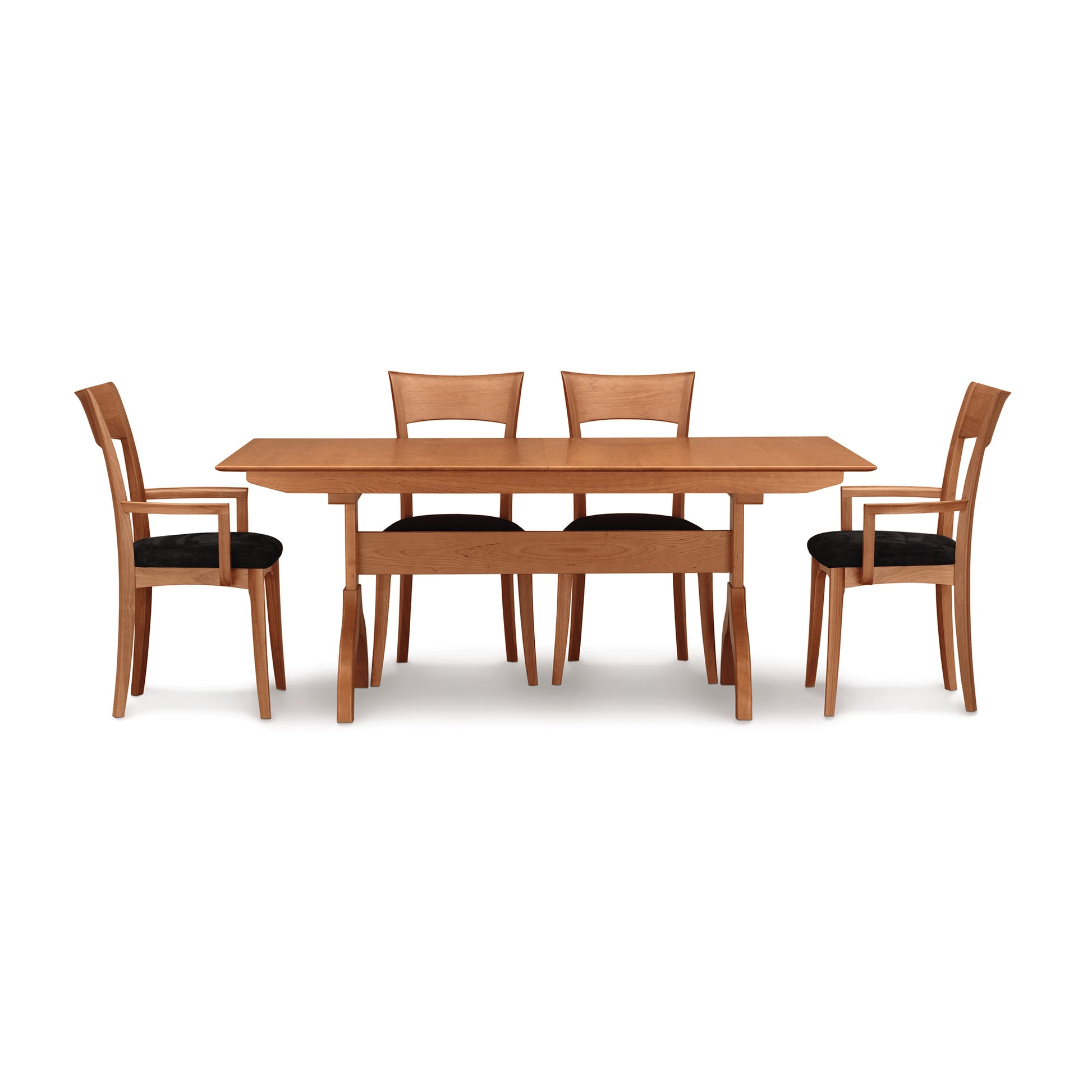 Copeland Sarah Shaker Trestle Extension Table with four Shaker collection chairs featuring black cushions, showcasing finely crafted wood furniture.