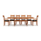 A wooden Sarah Shaker Trestle Extension dining table set with eight matching chairs from Copeland Furniture, presented against a white background.