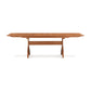 Sarah Shaker Collection cherry Copeland Furniture trestle-style extension dining table with extendable leaves on a plain background.