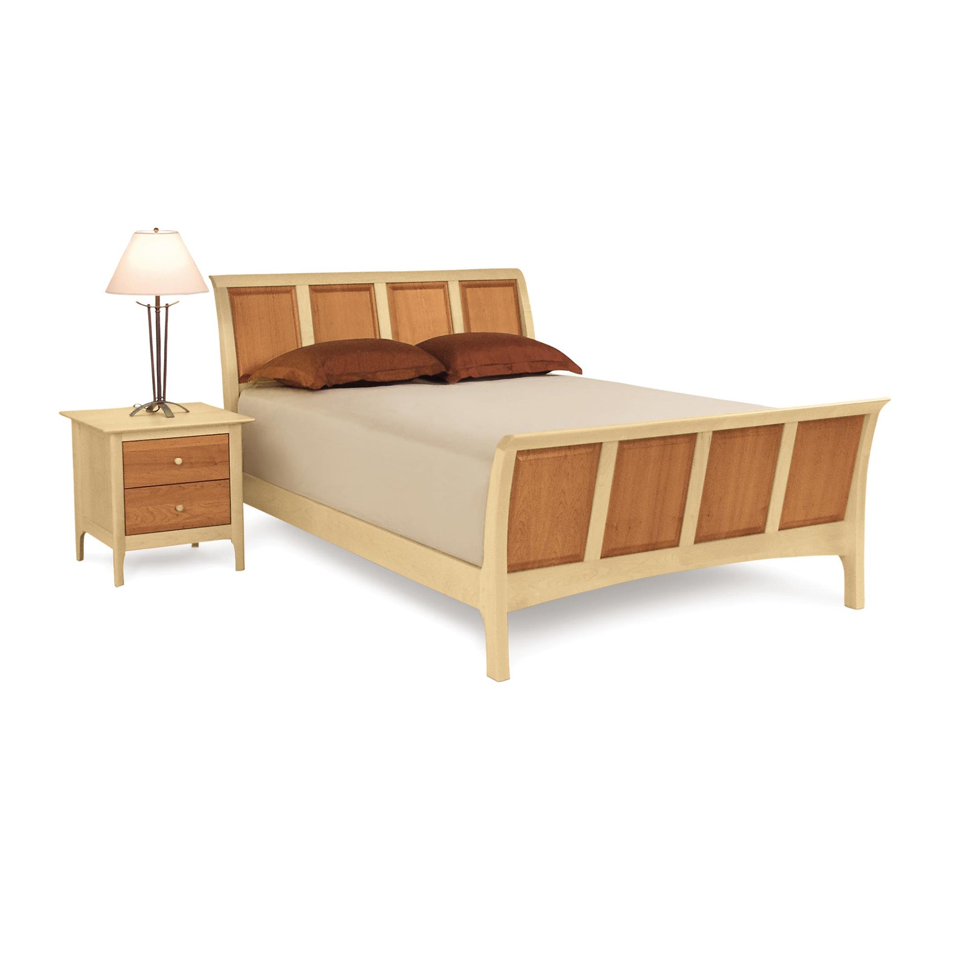 Sarah High Footboard Sleigh Bed by Copeland Furniture in natural wood, shown with brown pillows and beige bedding. Two-drawer nightstand partially visible.