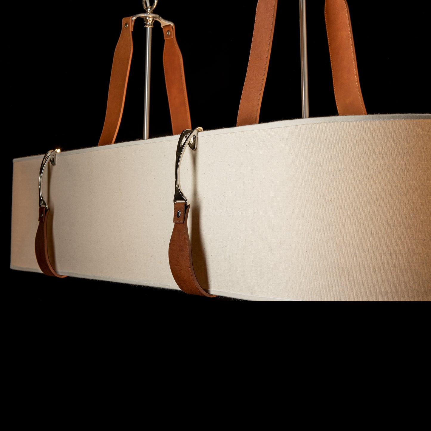 Saratoga Oval Pendant by Hubbardton Forge showcasing beige fabric and brown leather design with silver hardware.