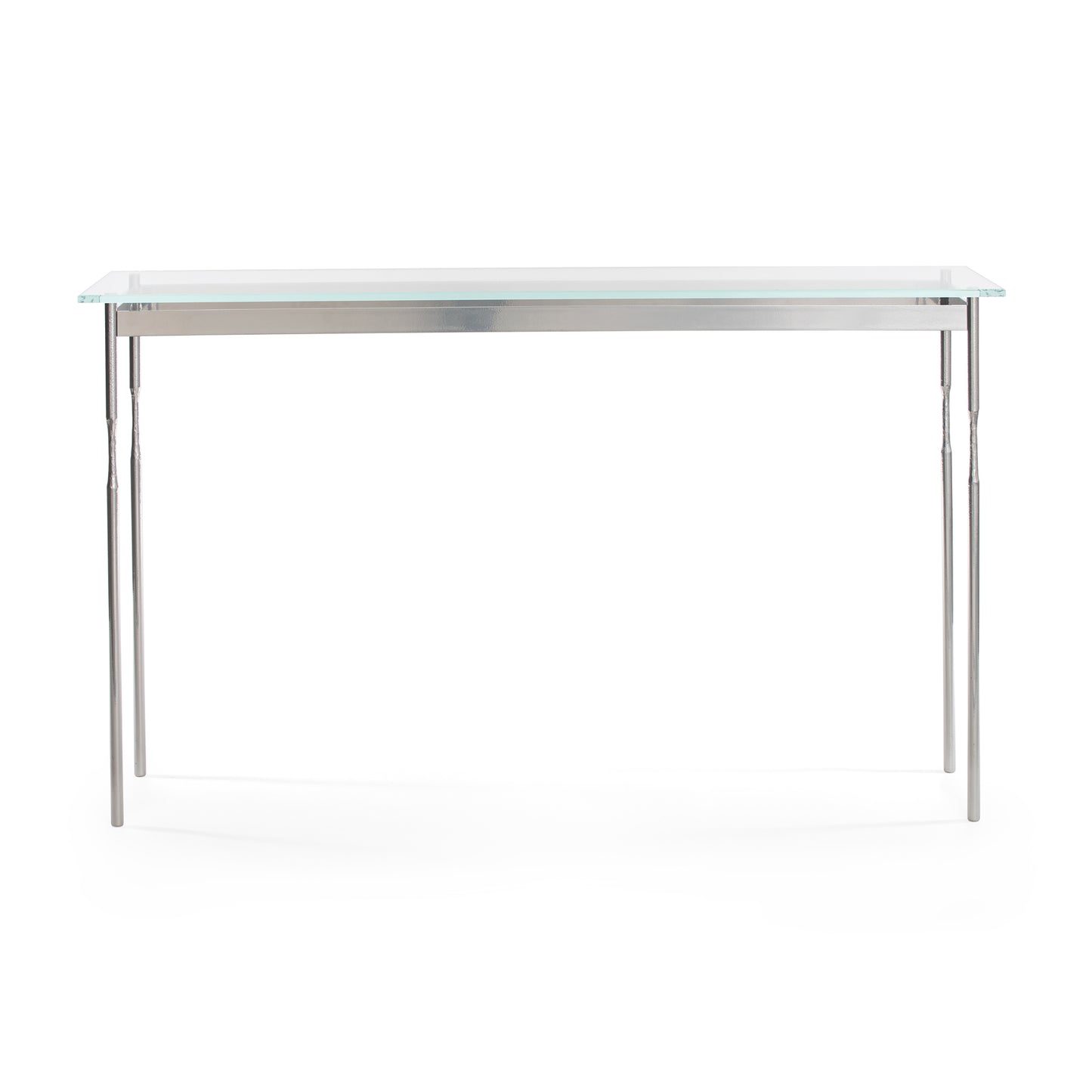 A Hubbardton Forge Senza console table with a tempered glass top and metal legs on a white background.