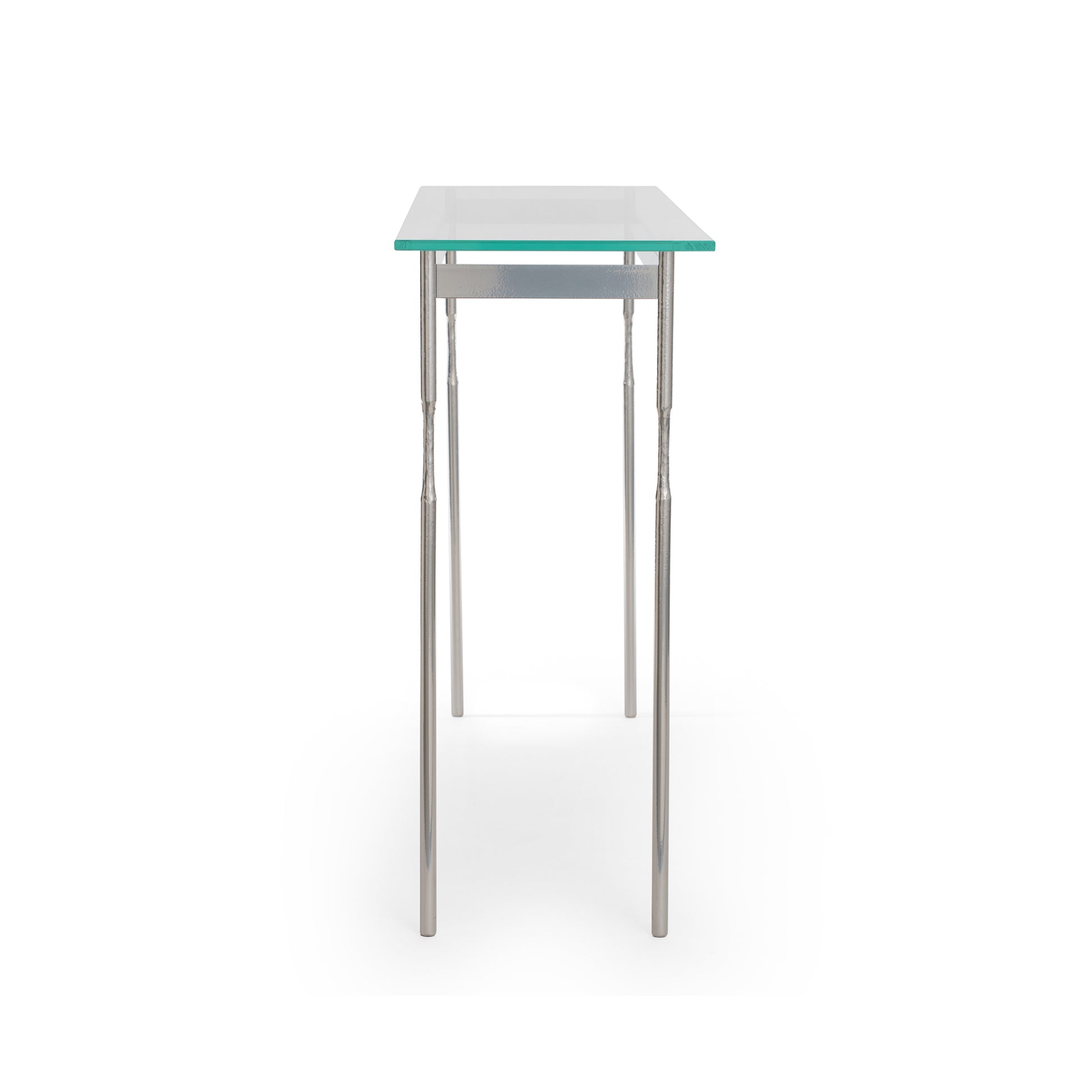 Hubbardton Forge Senza Console Table with a modern design, featuring a tempered glass top and elegantly handcrafted steel legs.