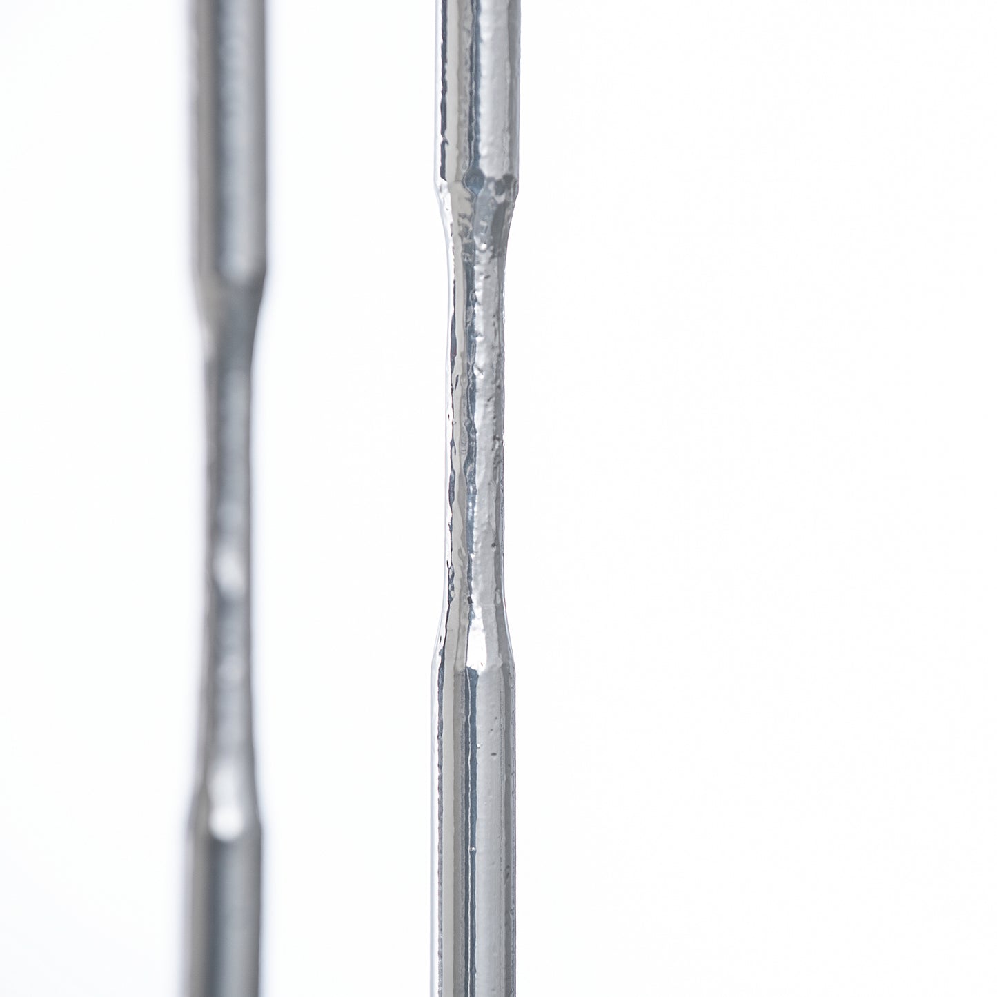 Detailed view of handcrafted tapered steel rods from the Senza Console Table by Hubbardton Forge.