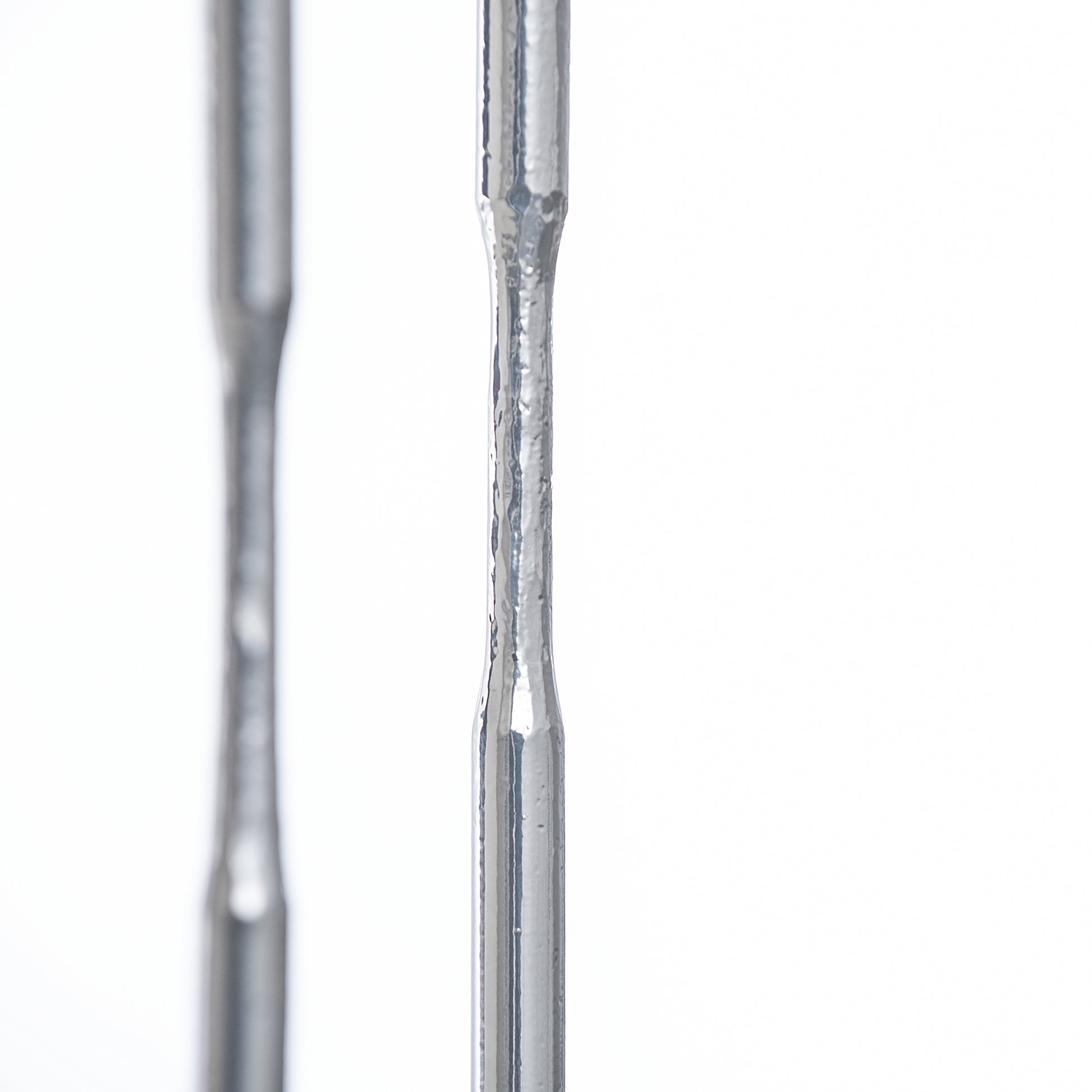 Detailed view of handcrafted tapered steel rods from the Senza Console Table by Hubbardton Forge.