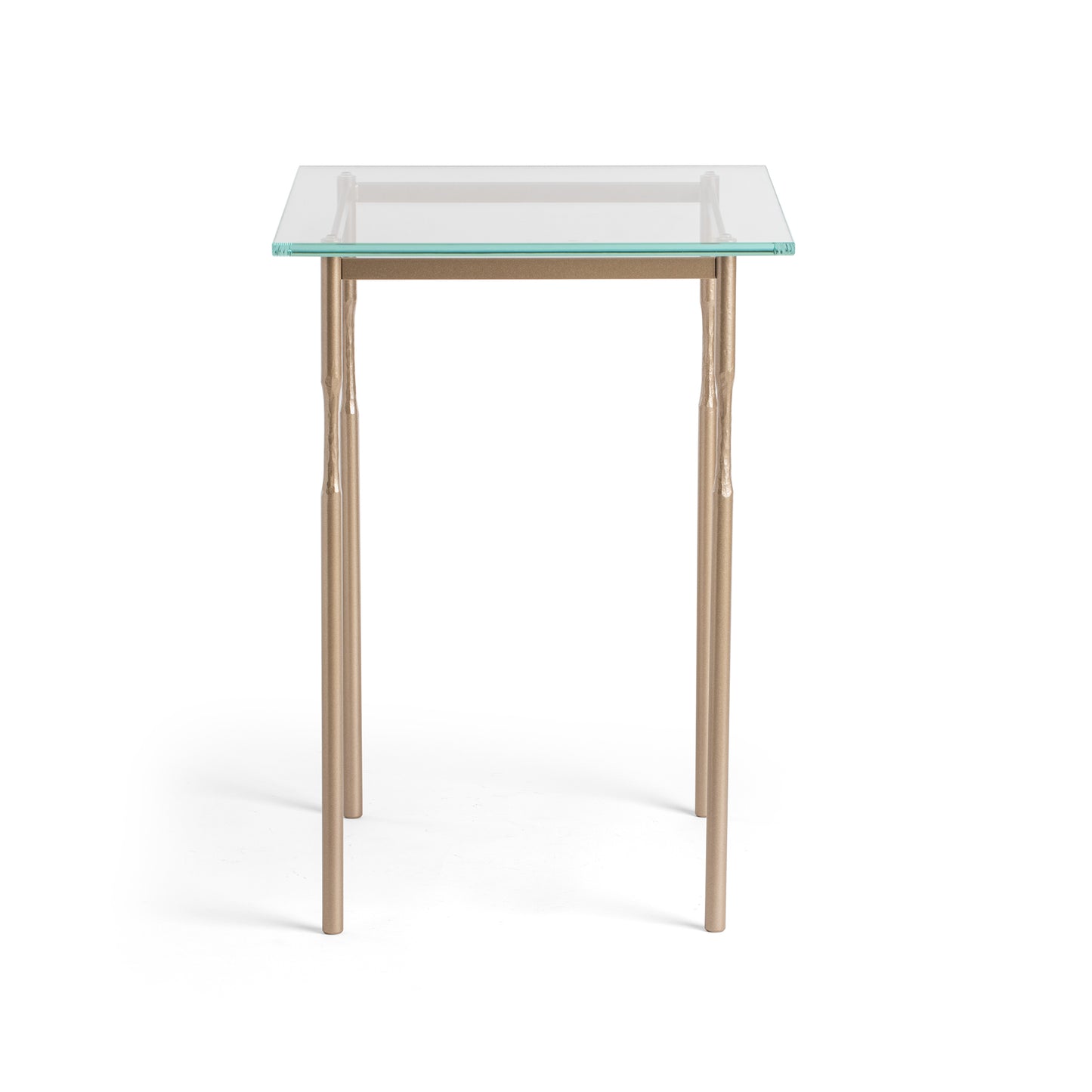 The Hubbardton Forge Senza Side Table is a modern home furniture piece featuring a glass top and elegant metal legs. It offers a sleek and contemporary look, making it perfect for any fine-tailored living.