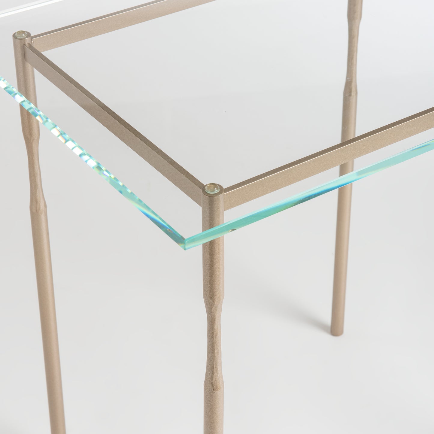Hubbardton Forge Senza Side Table with steel frame and glass top, showcasing artisanal craftsmanship for modern interiors.