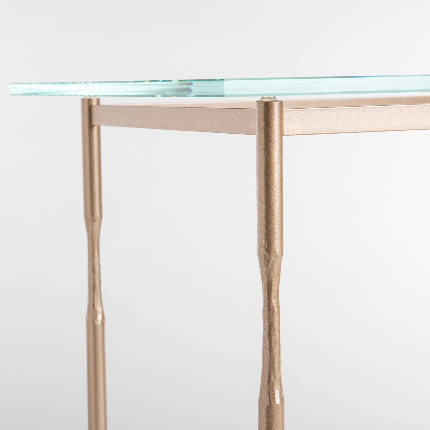 Hubbardton Forge Senza Side Table with glass top and sleek bronze legs, perfect for contemporary interiors.