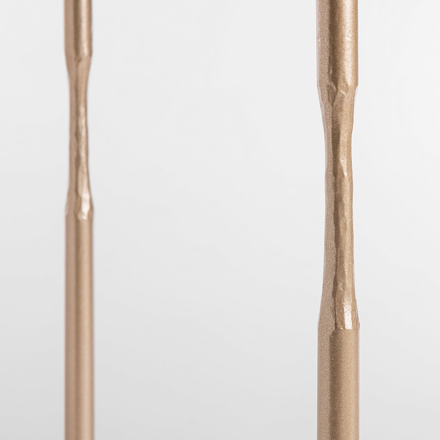 Close-up of textured metallic rods from handcrafted Hubbardton Forge Senza Side Table.