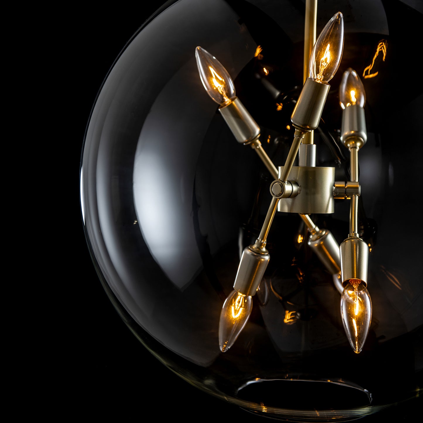 Sfera 6-Light Pendant by Hubbardton Forge with exposed bulbs in clear glass orbs, showcasing a brass finish.
