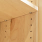 A close-up of a Lyndon Furniture Custom Shaker Wide Bookcase with Full Glass Doors - Clearance with oak stain finish.