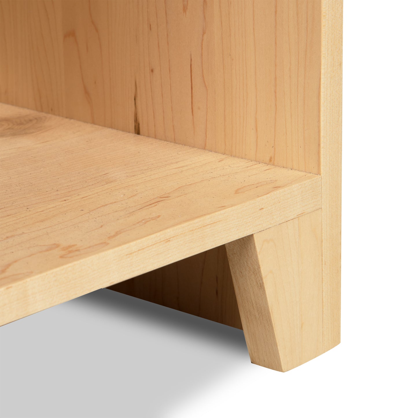 Close-up of Shaker Wide Bookcase by Lyndon Furniture, highlighting intricate wood grain and craftsmanship in the corner and leg design.